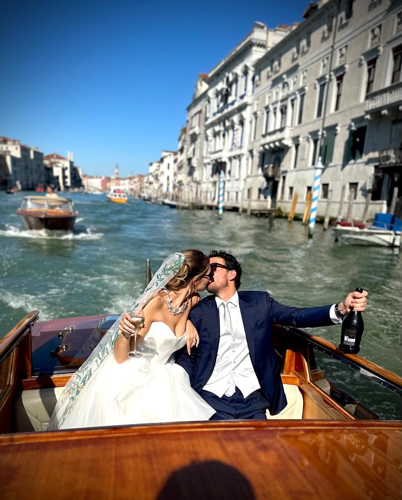 Bride and groom on a boat in Venice